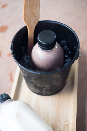 Chocolate flavor milk in bottle plastic in bucketの写真素材