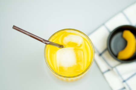 Freshly squeezed sweet orange juice with ice cubes, top viewの写真素材