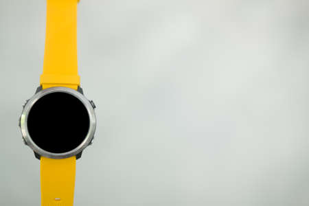 Modern smart watch with empty screen and yellow watch strapの写真素材