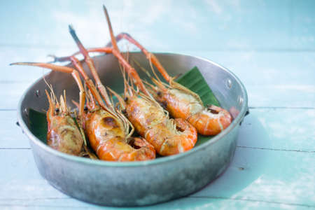 Grilled shrimp in bowl is very tasty on wood backgroundの写真素材