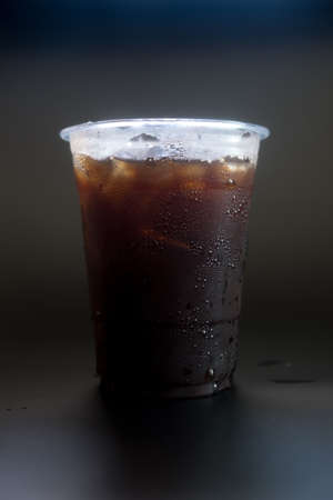 Ice black coffee in transparent glass with black backgroundの写真素材