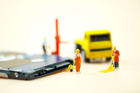 Miniature people: Workers pulling a pallet truck with circuit board moving for sent to repair....
