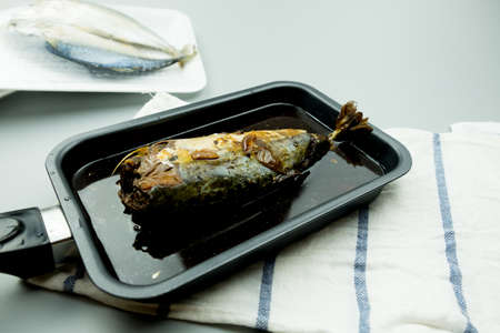 Mackerel fish boiled with Thai native sauce served in black pan