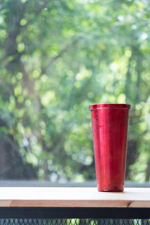 Red stainless steel tumbler for keeping of the drink cold with water drop. Concept of reduce plastic pollution.の写真素材