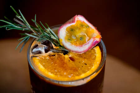 Iced black coffee mix with passion fruit juice and orange juice and decoration with orange slice and...