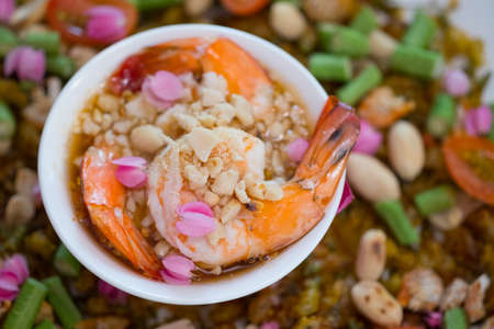 Light salad with boiled prawns and nut in white bowls, appetizer