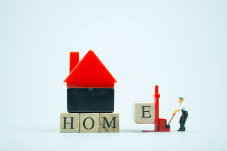 Close-up of miniature workers using the forklift to complete the with block E pieceの写真素材