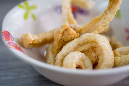 Thai crispy pork rinds in white bowlの写真素材