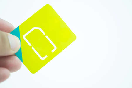Close up of a hand holding a blank new sim card