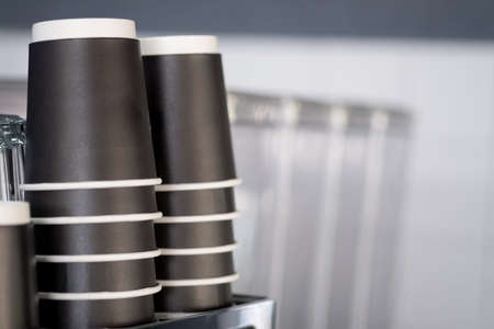 Stock black paper coffee to go cup in coffee shop
