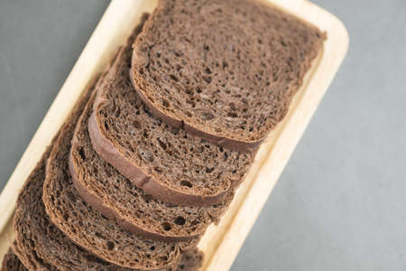 Chocolate bread sliced on wooden tray