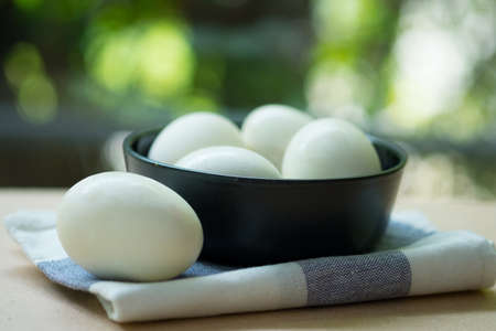Selective focus of salted egg in black bowl