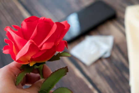 Roses flower with condom background. Protect health prevent. World AIDS Day.の写真素材