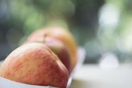 Close up of red apples on paper box