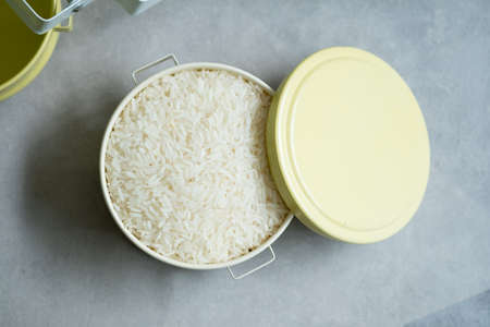 Raw white Jasmine rice in a part of food carrier thai style in tiffin Thai food carrier