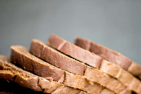 Chocolate bread sliced on black background. Selective focus