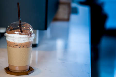 Iced coffee mocha with foam milk in takeaway cupの写真素材