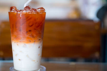A Glass of milk tea or Thai milk tea. Close upの写真素材