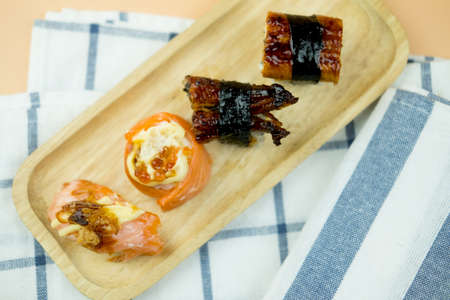 Close up of sashimi sushi set on wood tray, top view