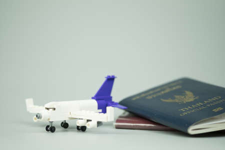 Miniature toy airplane and Thai citizen passport and Thailand official passportの写真素材
