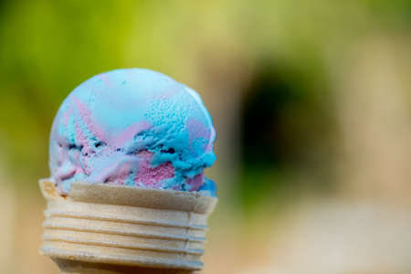 Ice cream in waffle cone. Strawberry mix raspberry flavor sweet. Ice cream is a summer favorite with...