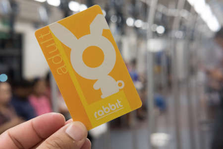 Bangkok, Thailand - August 12, 2019 : Hand holding BTS train ticket in Bangkok, BTS or Skytrain is one of the most convenient methods to travel around Bangkok.のeditorial素材