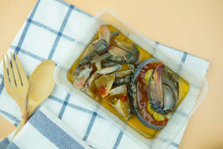 Pickled crab eggs in fish sauce pack in plastic box. Exotic menu in Thailand. Pickled crab eggs in...