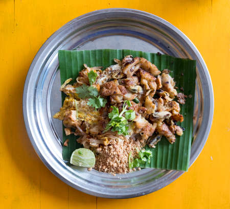 Fried mussel pancakes and Pad Thai served mix in dishの写真素材