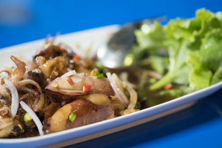 Sweet boiled squid (Thai called maug toam whan) topping with Chilli and onion