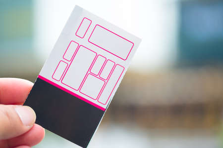 A hand holds paper movie ticket. Template design for advertising