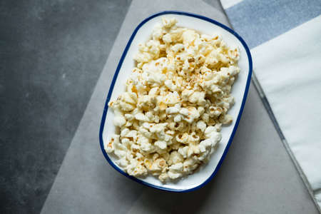 Tasty salt popcorn or cheese popcorn in bowl, top viewの写真素材