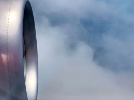 The turbine of the airplane above the clouds closeup, view from the portholeの写真素材