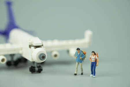 Miniature people: Traveller with backpack tourism by airplane. Travel, explore and adventure conceptの写真素材