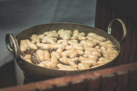 Fried dough or Patongko in big pan for sell in morning market of Thailand.の写真素材