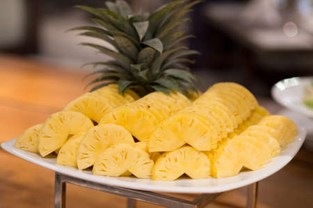 Pineapple sliced on plate in restaurant. Ready to eatの写真素材