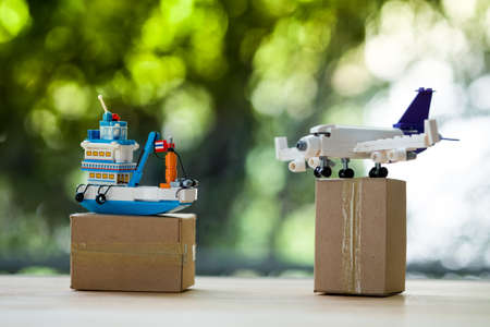 Miniature Thai ship and plane on brown box. Concept of cargo and shippingの写真素材