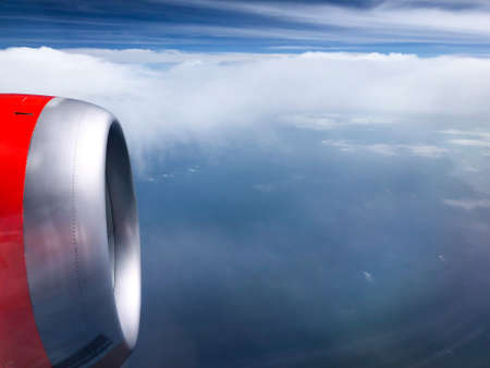 The turbine of the airplane above the clouds closeup, view from the porthole