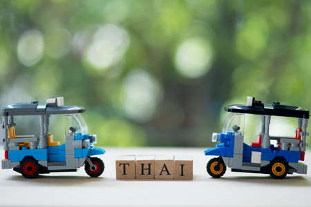 Three wheel taxi name Tuk Tuk racing in Thailand. Conceup of travelling and partnership in Bangkok Thailandの写真素材