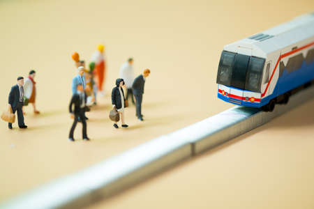 Close up miniature people waiting train at early morning rush hours, busy modern life concept. Thailand public transportation conceptの写真素材