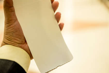 Businessman hand holding ticket plane on lighting background. Flight travel concept