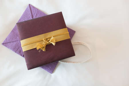 Silk gift box on purple mulberry paper bag