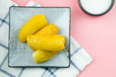 Thai dessert (Kluay Khai Chueam) : Baby bananas in heavy syrup, topped with coconut milk. Thai popular dessertの写真素材