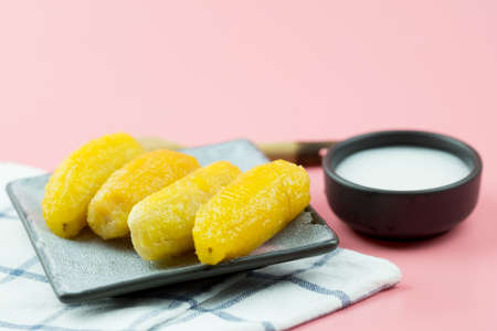Thai style banana in syrup with coconut milk. Very sweet dessert in Thailand. Preserved banana with...