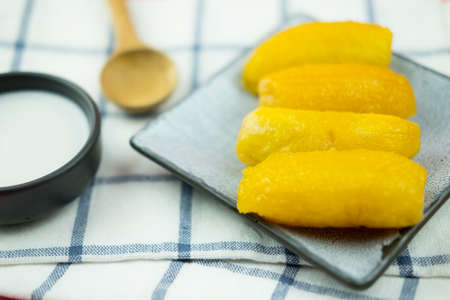 Sweet egg-banana (Pisang mas) in syrup topped coconut milk. Thai popular dessertの写真素材