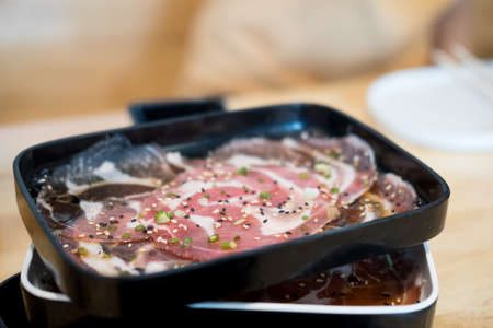 Raw beef being prepared on black tray , cooking meatの写真素材