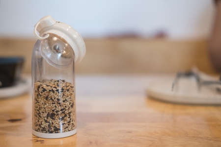 Mix of white and black sesame seeds in bottle