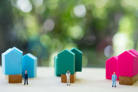 Miniature people : Team of bankers handing over a contract for home loan for coustomers. Concept of...