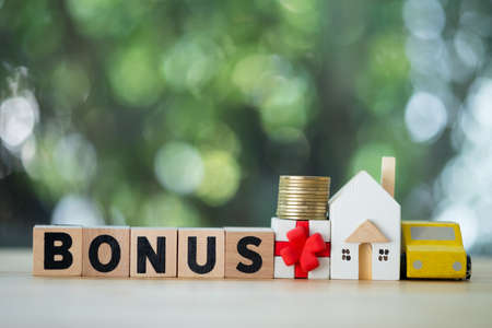 Letter block in word bonus with money, home and car. Bonus can pay for need in my lifeの写真素材