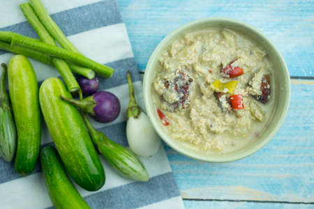 Herbed soya beans with minced pork in coconut milk served in white bowl, Thai food is called Tao Jiaw Loneの写真素材