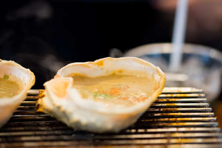 Japanese food, Kani Miso, crab miso grill on the stove at the restaurant (Selective focus)